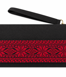 Black handmade Palestinian embroidered clutch with red geometric cross-stitch patterns and a detachable wrist strap.