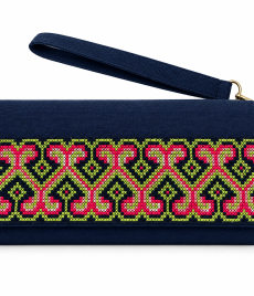 Hand-embroidered clutch with repeating curling geometric vine-like motifs embroidered in pink and lime green on navy fabric, shown on a white background with a wrist strap