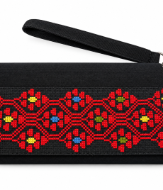 Hand-embroidered clutch with connected red geometric flowers with small centres in blue, yellow and olive green, shown on a white background with a wrist strap.