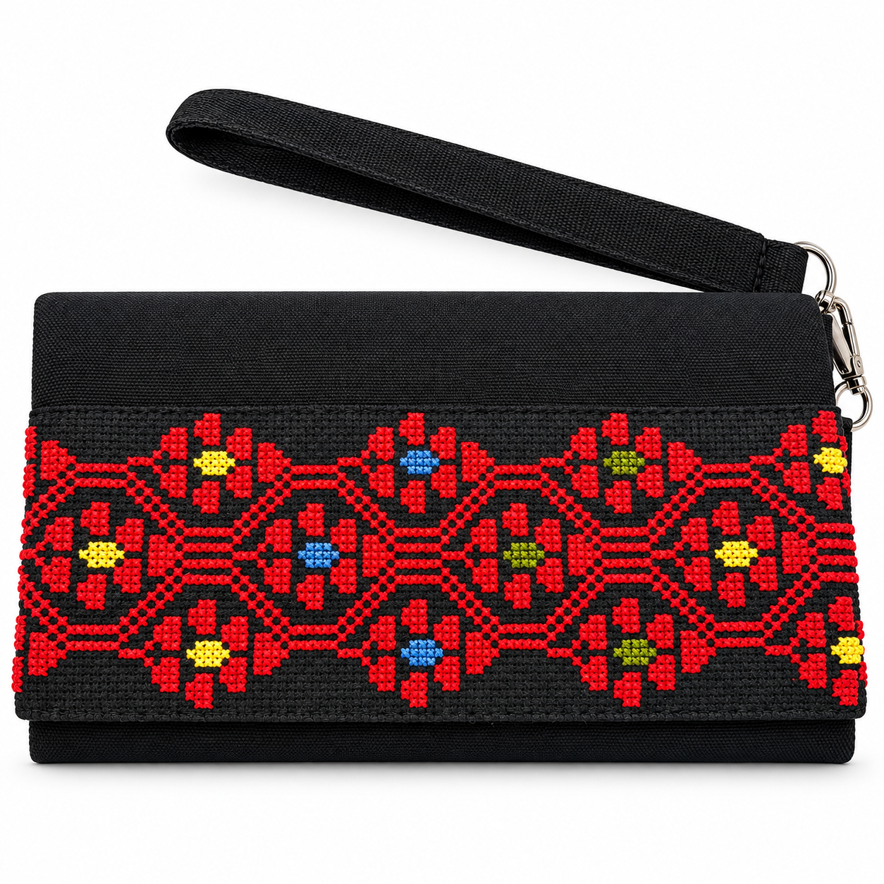 Hand-embroidered clutch with connected red geometric flowers with small centres in blue, yellow and olive green, shown on a white background with a wrist strap.