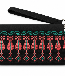 Hand-embroidered clutch with repeating elongated leaf- or cypress-like shapes in coral pink, linked to small diamonds, with teal accents, shown on a white background with a wrist strap