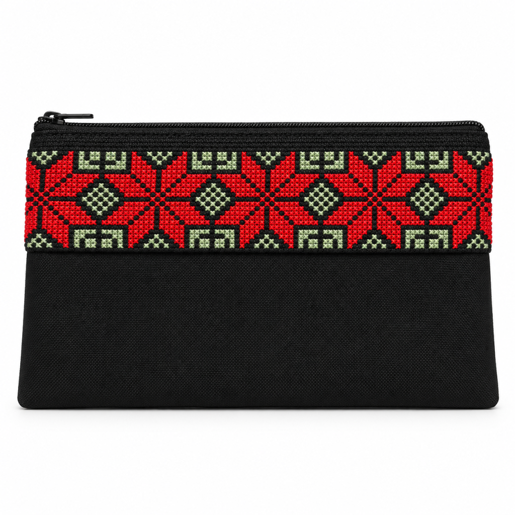 Handmade black embroidered zipper pouch with red geometric cross-stitch pattern